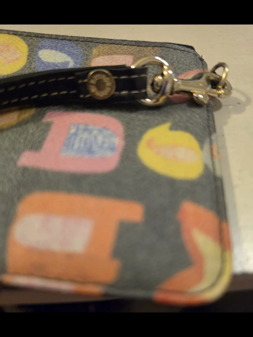 Dooney & Bourke Vintage multicolor letter/graffiti print coated Wristlet